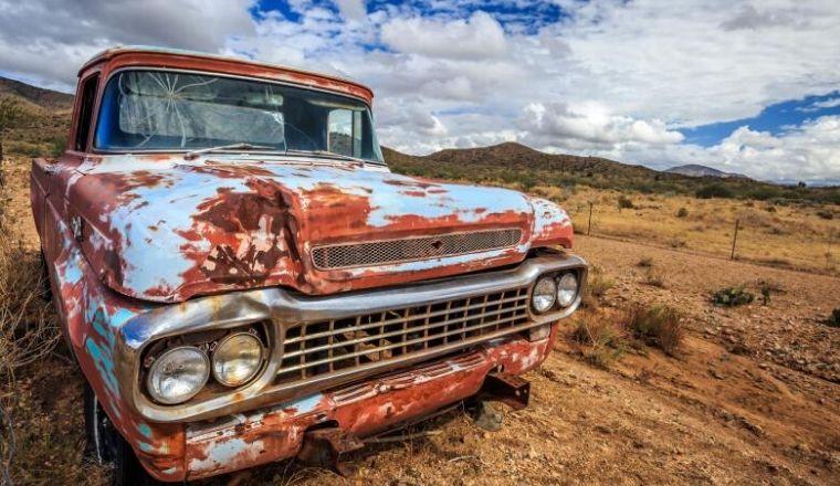 Rusty old car in desert